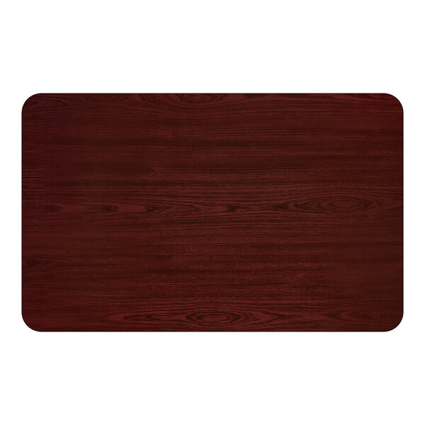 A rectangular bar height table with a reversible cherry and black finish and a cast iron base.