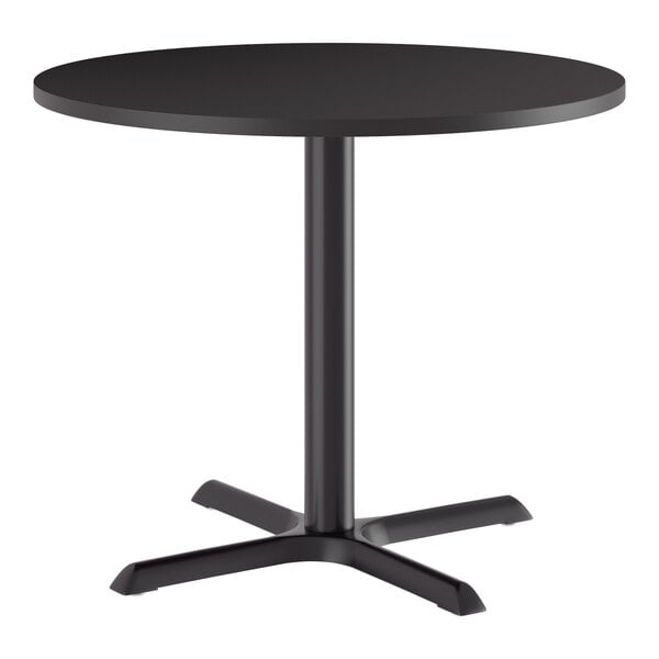 A round black standard height table with a cast iron base.
