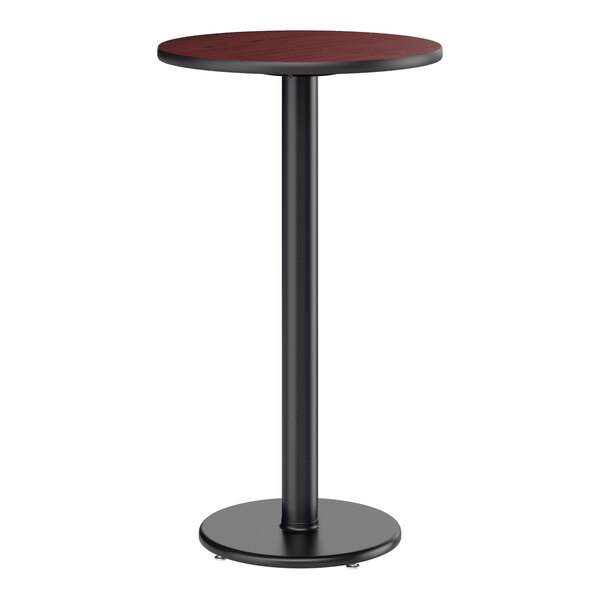 A round bar height table with a reversible cherry and black top and a black cast iron base.