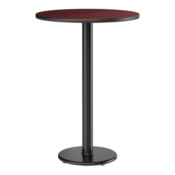 A round bar height table with a reversible cherry and black top and a black cast iron base.