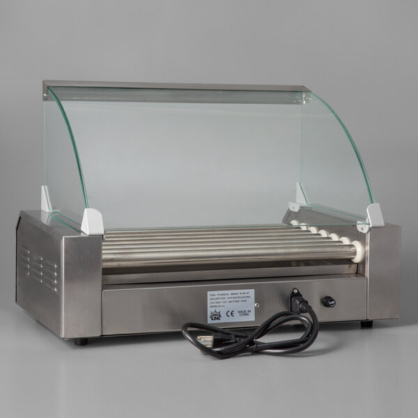 A Grand Slam stainless steel hot dog roller with a glass sneeze guard.