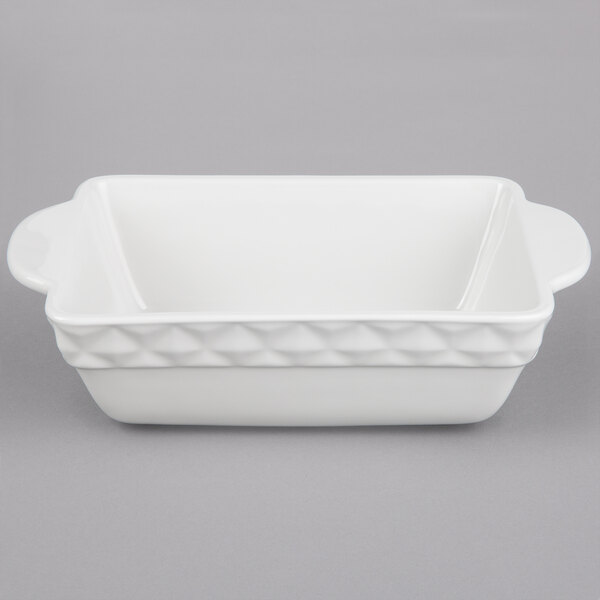 A white rectangular ceramic casserole dish with handles and a black border.