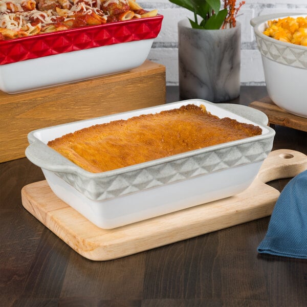 A white rectangular Tuxton casserole dish with brown food in it.