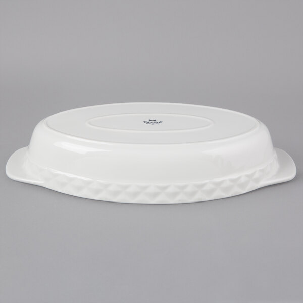 A white Tuxton oval china casserole dish with a diamond patterned lid.