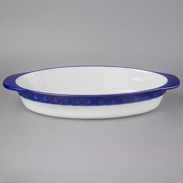 A white oval casserole dish with a blue rim.