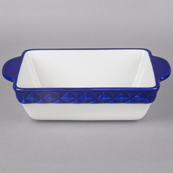 A white rectangular china casserole dish with cobalt blue accents.