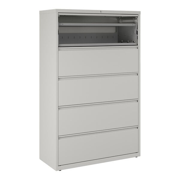 A gray five-drawer lateral file cabinet with a roll-out binder storage compartment at the top.