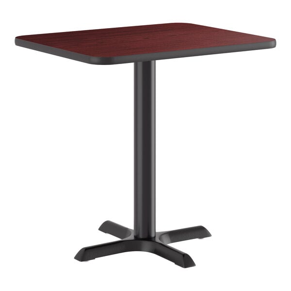 A standard height table with a reversible cherry and black rectangular top and a black cast iron base.