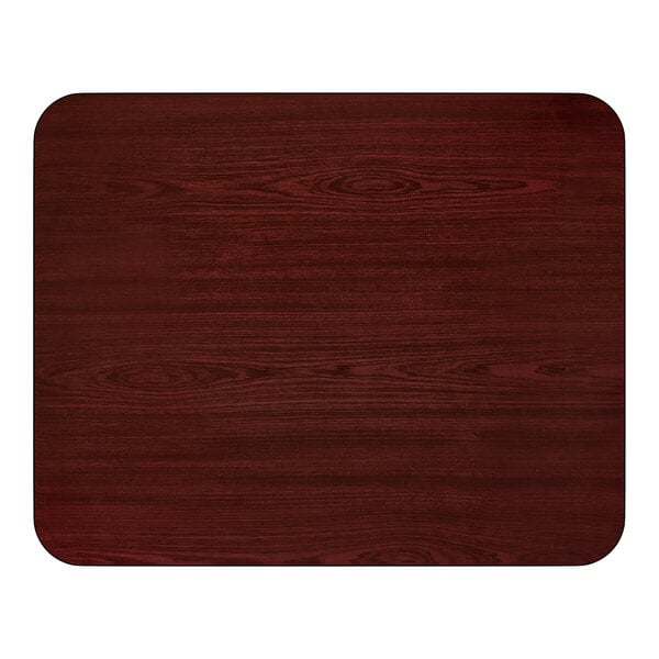 A rectangular reversible table top with a cherry wood finish and rounded corners.