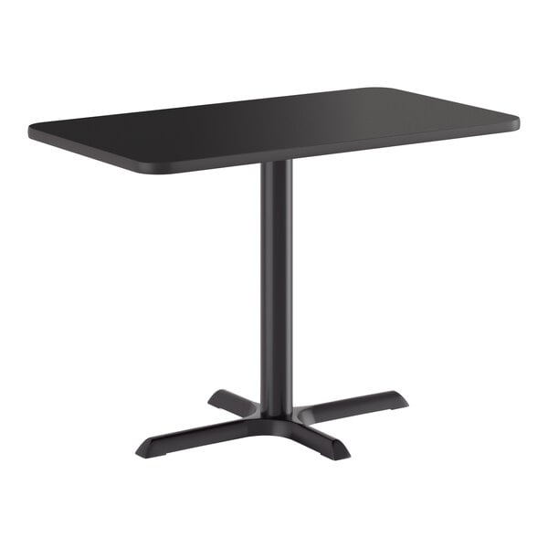 A rectangular black standard height table with a cross-shaped cast iron base.