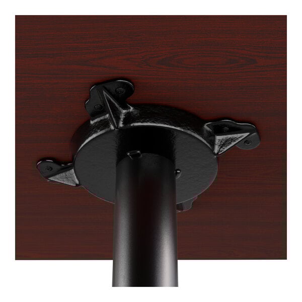 A standard height table and base kit featuring a reversible cherry and black tabletop with a cross cast iron base.