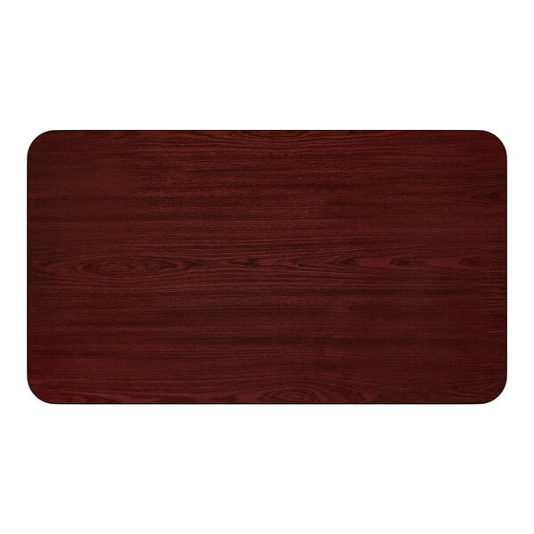 A rectangular standard height table with a reversible cherry and black finish and a cross cast iron base.