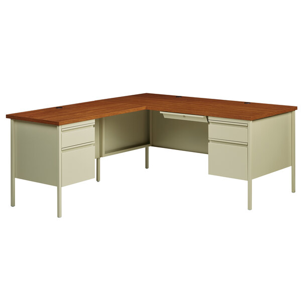 A Hirsh Industries left corner pedestal desk in putty oak with two drawers.