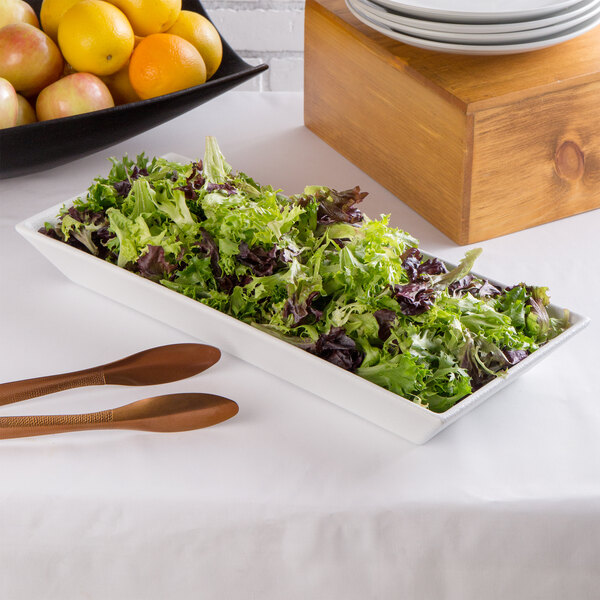 A G.E.T. Enterprises white resin-coated aluminum deep rectangular platter with salad and fruit on it.
