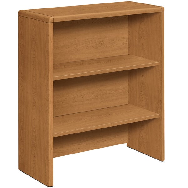 A HON Harvest laminate bookcase hutch with two shelves on a wooden desk.