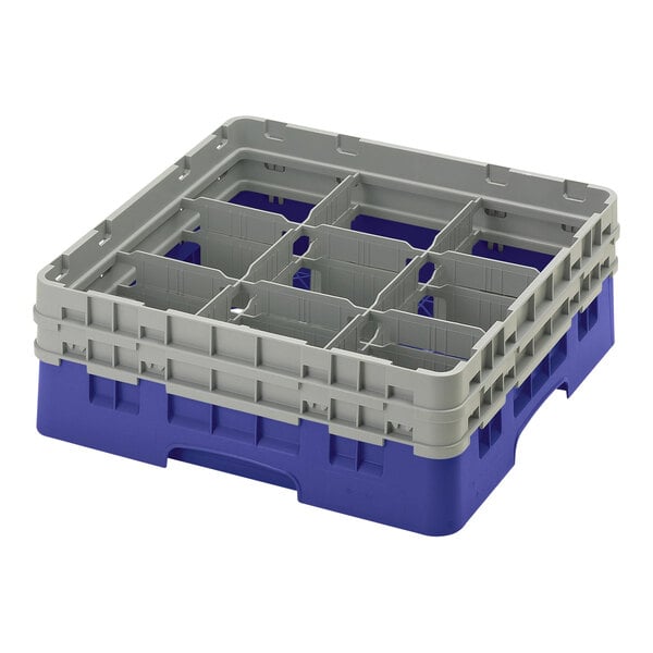 A blue plastic Cambro glass rack with 9 compartments.