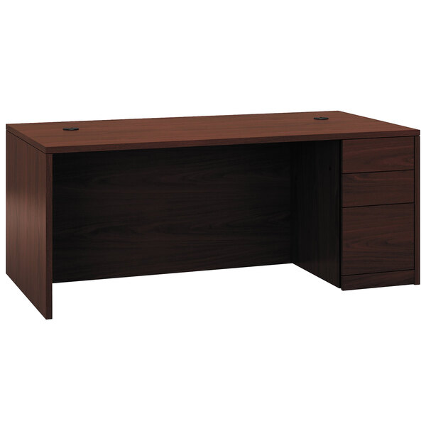 A brown HON laminate pedestal desk with drawers.