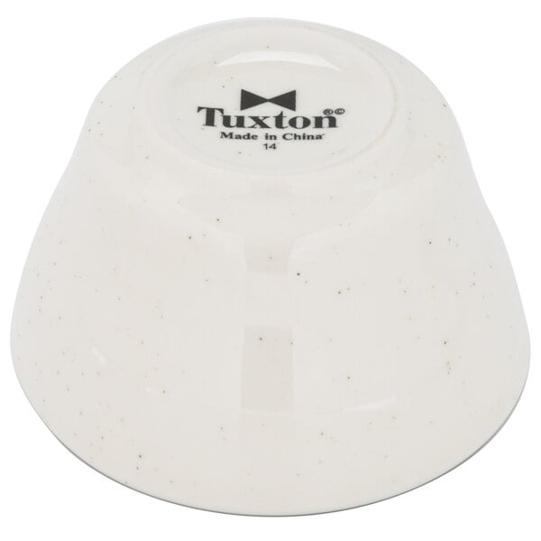 A white Tuxton narrow rim bowl with black text.