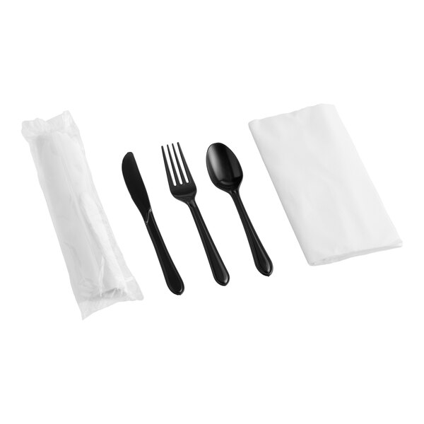 A pre-rolled and individually wrapped set containing a white linen-like napkin and black extra heavy weight plastic cutlery including a knife, fork, and spoon.