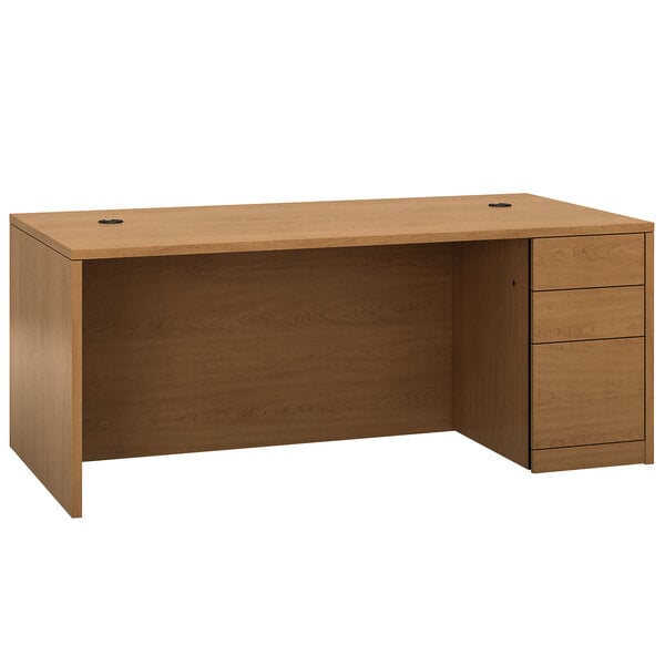 A HON Harvest laminate single pedestal desk with a cabinet and drawers.