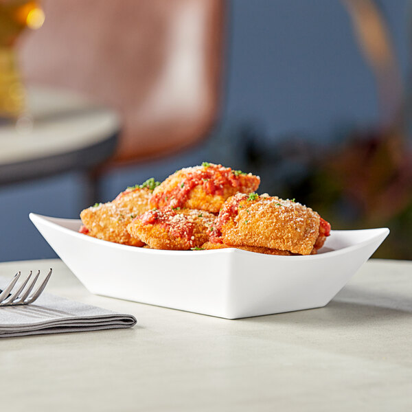 A white rectangular Tablecraft serving dish with food in it.