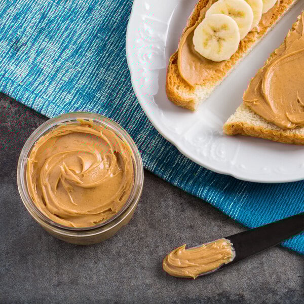 A plate of toast with Producers Peanut Company peanut butter and banana slices.