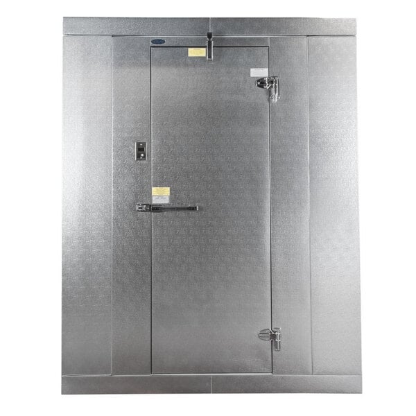 A large, metallic indoor walk-in freezer with a single door and heavy-duty latches.