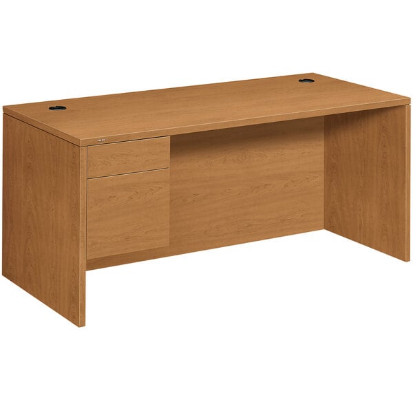 A brown HON 10500 series pedestal desk with a drawer.