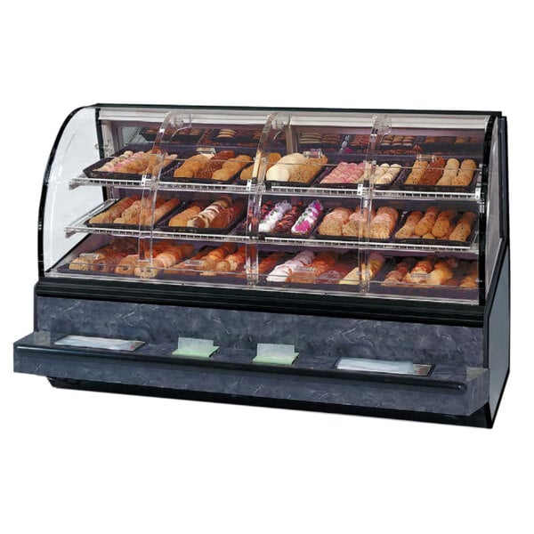 A Federal Industries Series '90 curved dry self-service bakery case on a bakery counter with a variety of pastries.