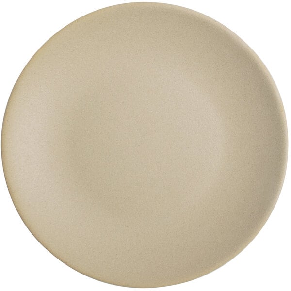 A close-up of a Tuxton Zion matte beige coupe plate.