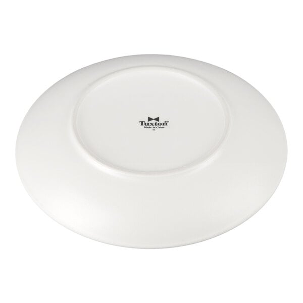 A Tuxton TuxTrendz white china plate with a black rim.