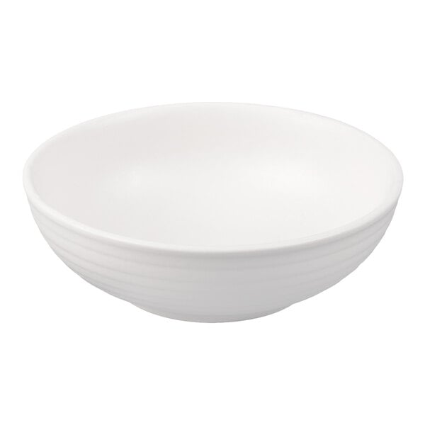 A Tuxton TuxTrendz Zion matte white china bowl with a curved edge.