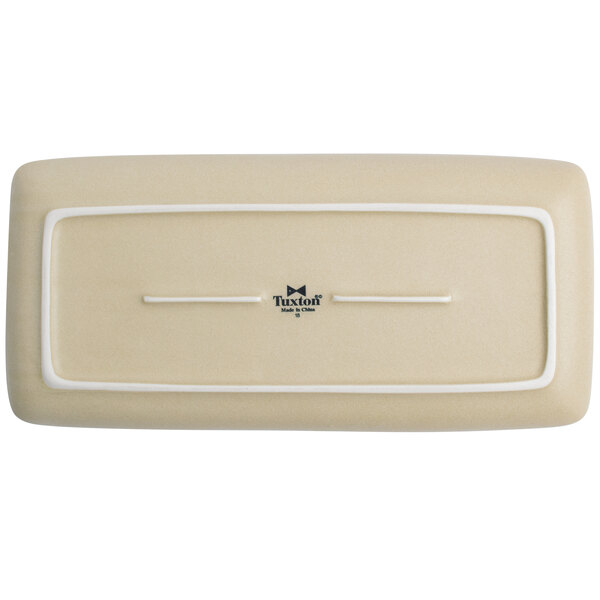 A rectangular beige china tray with an embossed white border.