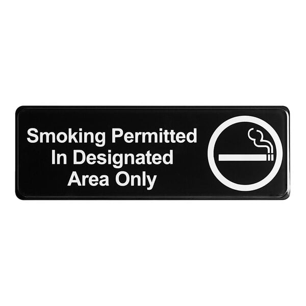 A black and white sign that says "Smoking Permitted In Designated Areas Only"