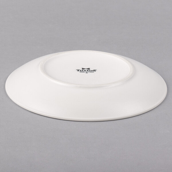 A Tuxton TuxTrendz white china plate with a coupe shape.