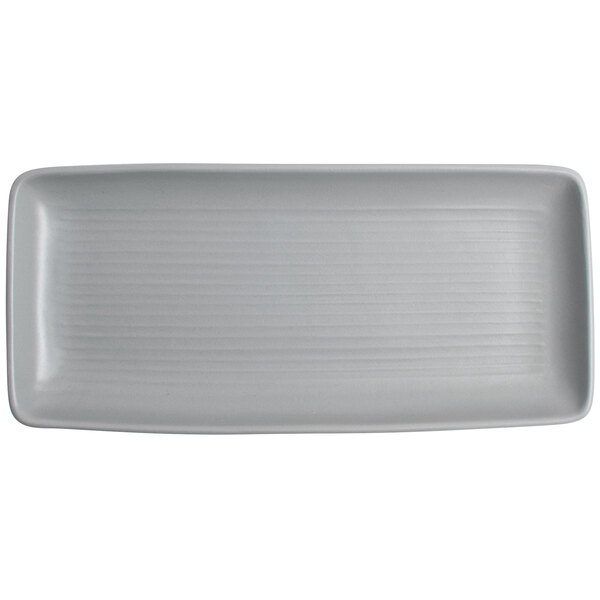 A rectangular white Tuxton China tray with a ribbed pattern.