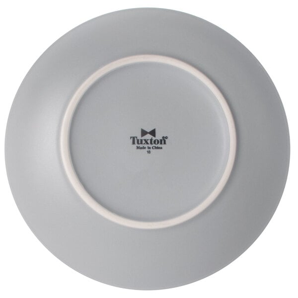 A gray Tuxton china plate with a white rim.