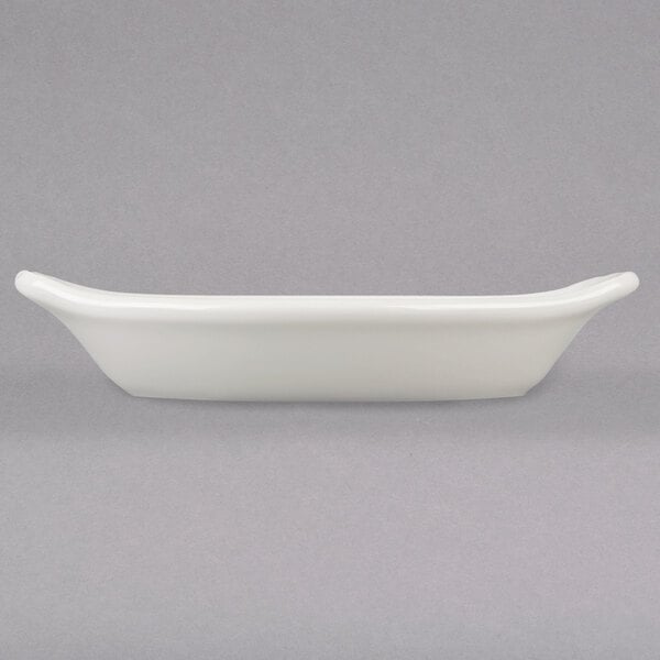 A white rectangular Hall China au gratin dish with a handle.