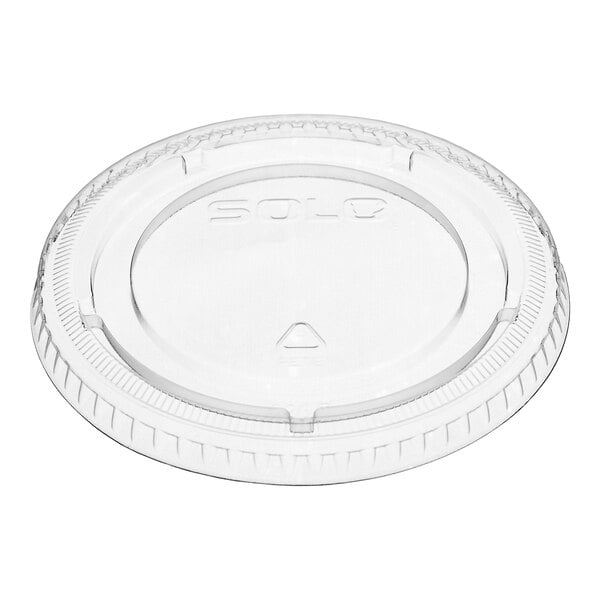 A clear, round plastic lid with a raised edge and embossed text in the center.