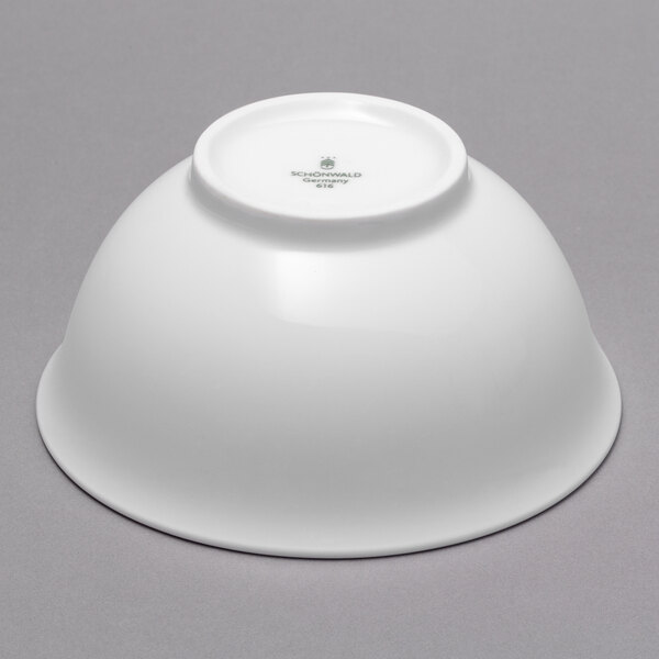 A dark blue Schonwald porcelain bowl on a gray background.