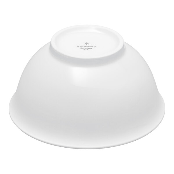 A white porcelain bowl shown upside down on a plain background.