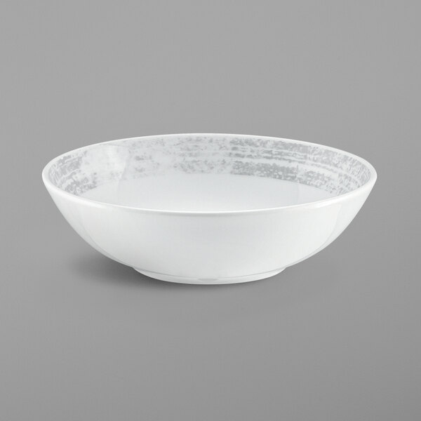 a white bowl with a silver rim