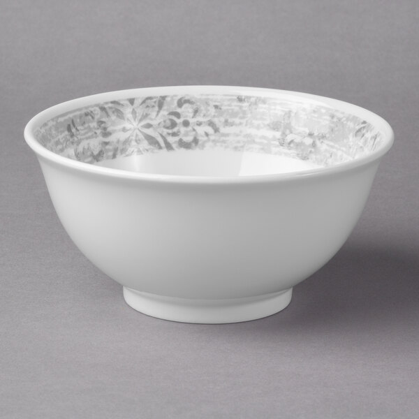 A white bowl with a grey rim and silver design.