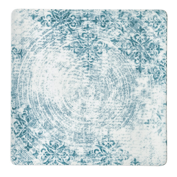 A close-up of a Schonwald square white porcelain plate with a blue and white floral pattern.