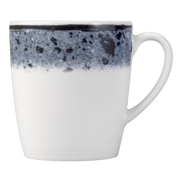 A white porcelain cup with a handle, featuring a speckled blue and black band around the rim.