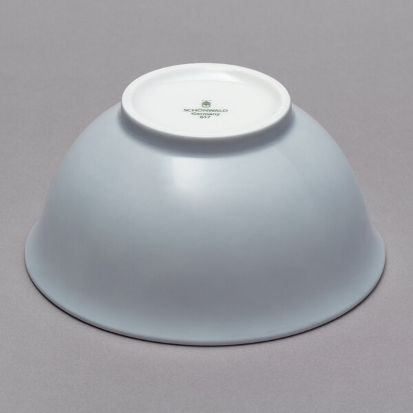 A white Schonwald porcelain bowl on a gray surface.
