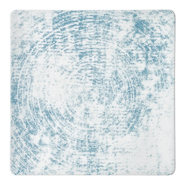 A white square Schonwald porcelain plate with a blue circular pattern.