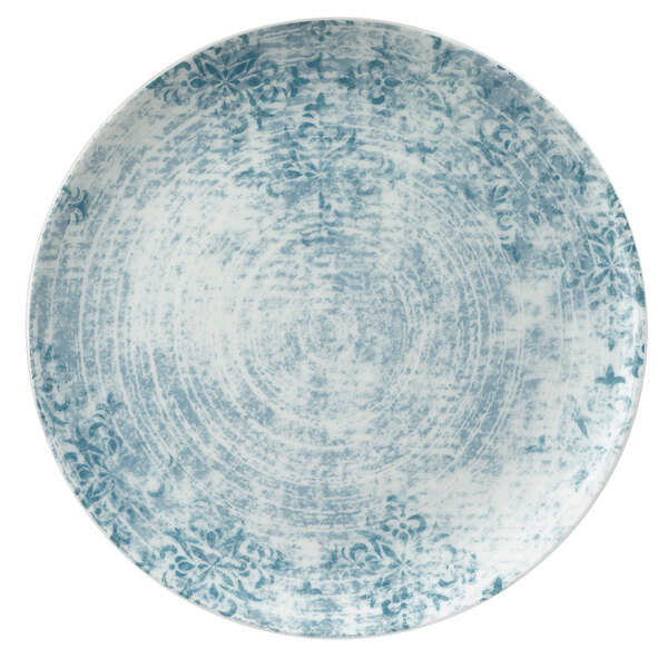 A Schonwald round porcelain coupe plate with a blue and white pattern of ornaments.