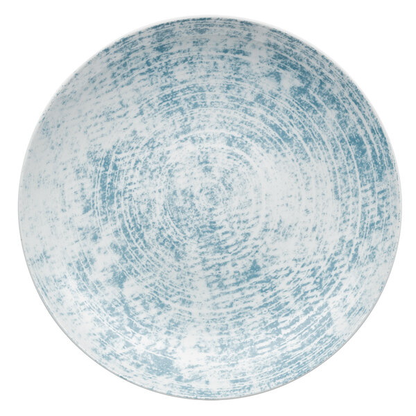 A close-up of a Schonwald Shabby Chic blue porcelain deep coupe plate with a white rim.