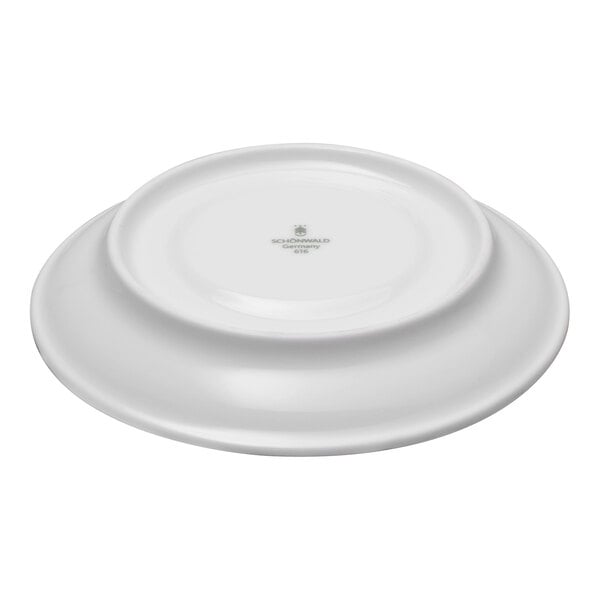 A white porcelain saucer shown upside down with a manufacturer's mark at the center.